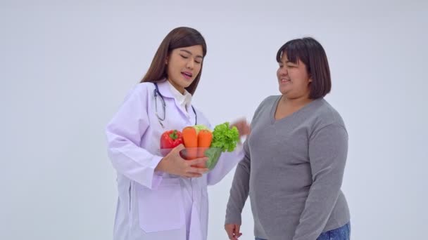 Doctor or nutritionist holding fresh fruit and introduce nutrition to patients. A healthy diet concept of nutrition food as a prescription for good health, the fruit is medicine. - Footage, Video
