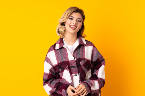 Young Russian woman isolated on yellow background laughing - Φωτογραφία, εικόνα