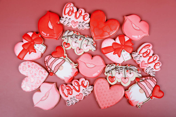 Closeup of variation of different cookies for valentines day. Heart, love and kiss cookie on pink background. Present gift or background for Valentine or Mothers day. Lovely sweet gift or postcard - Фото, изображение