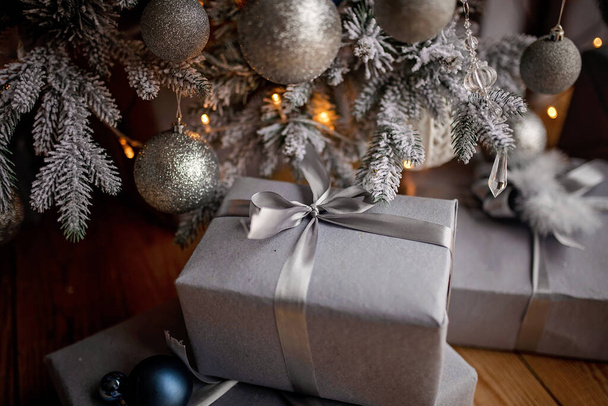 festively wrapped boxes under Christmas tree - Фото, изображение