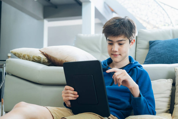 The boy using tablet to online communication at home - Foto, Bild