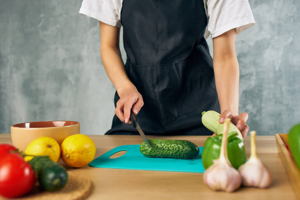 slicing cucumber on a cutting board vitamins vegetables salad - Foto, imagen