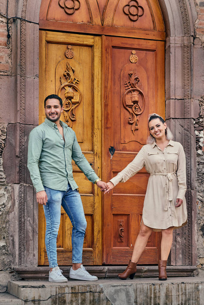 Young latin male and female couple in love looking at the camera between 25 and 35 years old - Foto, afbeelding