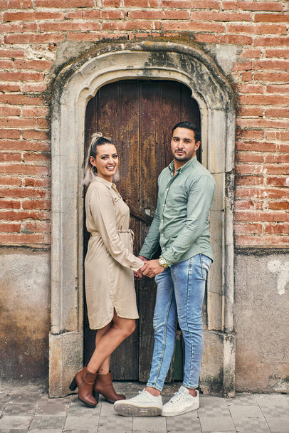 Young latin male and female couple in love looking at the camera between 25 and 35 years old - Foto, Imagen