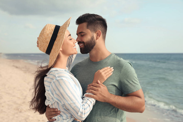 Lovely couple spending time together on beach - Фото, зображення