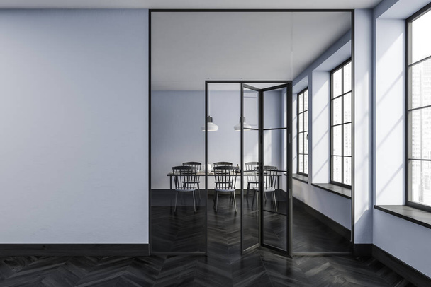 Blue eating room interior with wooden chairs behind glass doors, black parquet floor. Closed dining room with minimalist furniture. Copy space blank wall, 3D rendering - Photo, Image