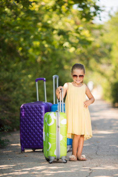 Beautiful young lady travelling with a suitcase - Fotoğraf, Görsel