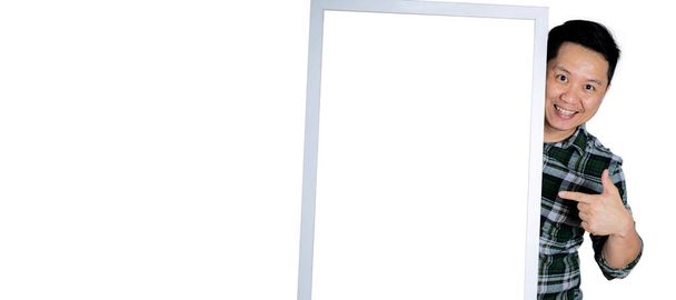 Happy young man in his 40s holding a gray frame. put your finger on the frame white isolated background - Foto, Imagem