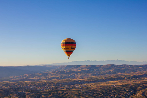 Cappadocia, Nevsehir, Turkey-September-2021: Blue sky and hot air balloons..Top view. Known as "Kapadokya" in Turkey - Фото, зображення
