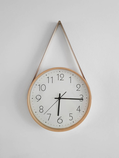 deviant classic clock hanging on a white wall, sign, piece of furniture - Photo, image