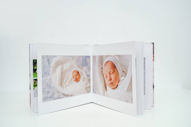 on white background photobook from photo shoot with a newborn child - Foto, immagini