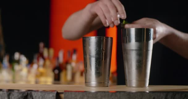Barman ajoute une feuille de shiso fraîche au shaker ouvert, la fabrication du cocktail avec de l'herbe périlleuse, le barman mélange des boissons froides sur le comptoir du bar, 4k 120 ips Prores HQ - Séquence, vidéo
