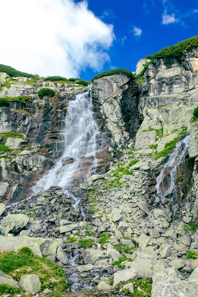 Panoramic view of Skok waterfall and the lake next to it in the western part of High Tatras, Slovakia - 写真・画像