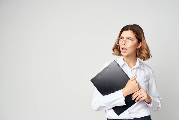 female manager with documents in hand work light background - Фото, изображение