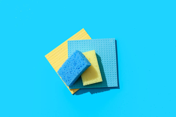 Cleaning sponges and rags on blue background - Fotografie, Obrázek