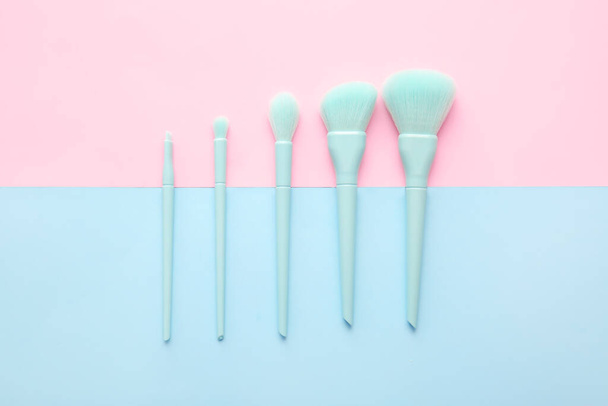 Set of beautiful makeup brushes on color background - Photo, Image