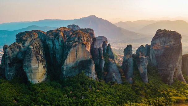 Aerial drone view of the Meteora in Greece at sunset. Rock formations. A lot of greenery, sacred place - Foto, imagen