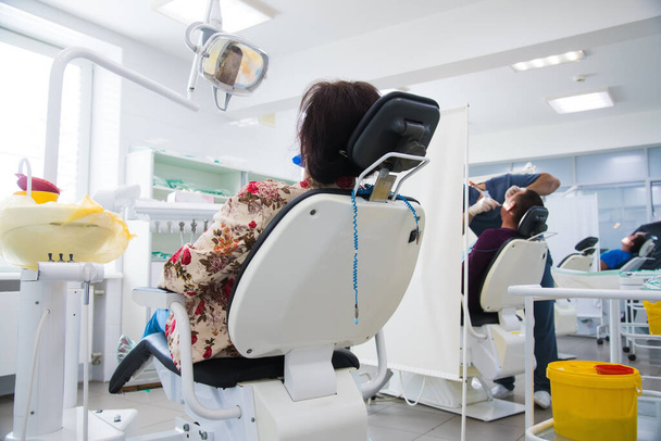 Woman receiving dental treatment. Dental clinic. Dental treatment. Dentist at work - Zdjęcie, obraz