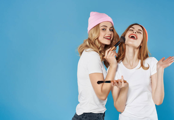 two funny girlfriends in hats message cosmetics care - Photo, Image