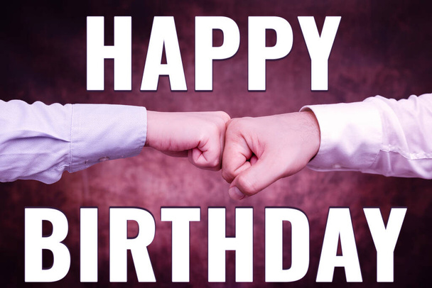 Conceptual caption Happy Birthday. Business overview The birth anniversary of a person is celebrated with presents Two Professional Well-Dressed Corporate Businessmen Handshake Indoors - Photo, Image