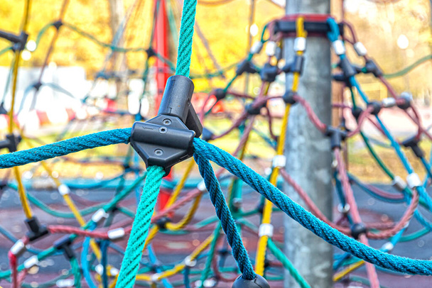 T-shaped plastic fastening connector for multicolored ropes at the children's rope complex in the city park - Photo, Image