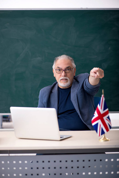 Old male english language teacher in the classroom - Photo, Image