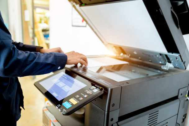 Bussiness man Hand press button on panel of printer, printer scanner laser office copy machine supplies start concept. - Φωτογραφία, εικόνα