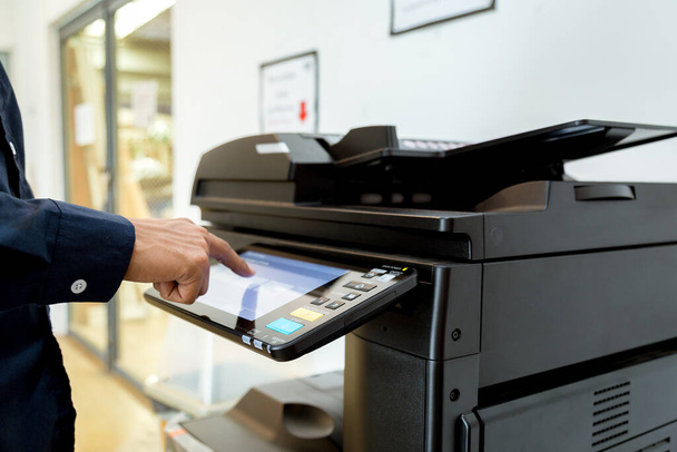 Bussiness man Hand press button on panel of printer, printer scanner laser office copy machine supplies start concept. - Photo, Image