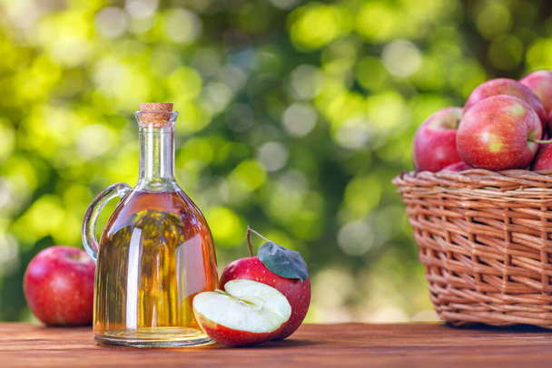 apple vinegar or cider in glass bottle outdoors - Foto, Imagen
