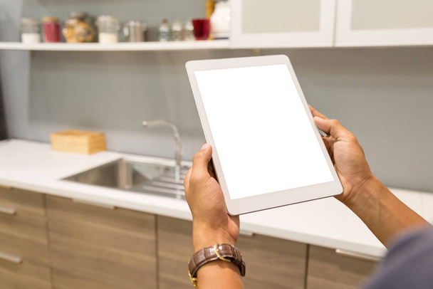 Mockup tablet on businessman hands empty display on home table with blur background. - 写真・画像