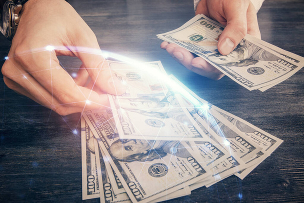 Multi exposure of social network theme drawing hologram and USA dollars bills and man hands. - Φωτογραφία, εικόνα