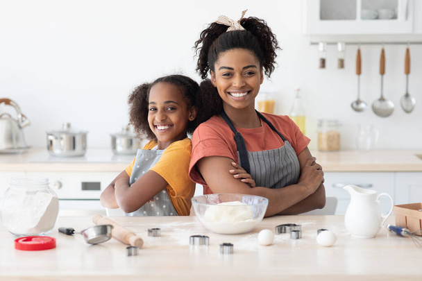 Cute african american mother and daughter posing while baking - Photo, Image