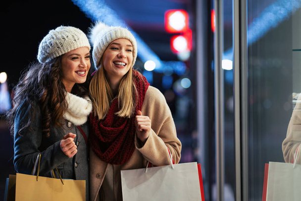 Portrait of cheerful young happy woman doing Christmas shopping. Christmas sale people concept - 写真・画像