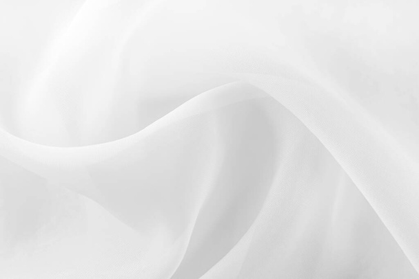 White fabric. The texture of the material, chintz or satin in a light shade with folds and waves. Cloth - Foto, Imagem
