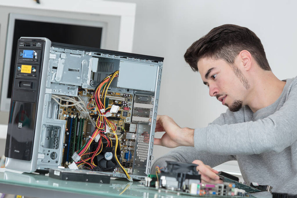 a computer repairman at work - Фото, изображение
