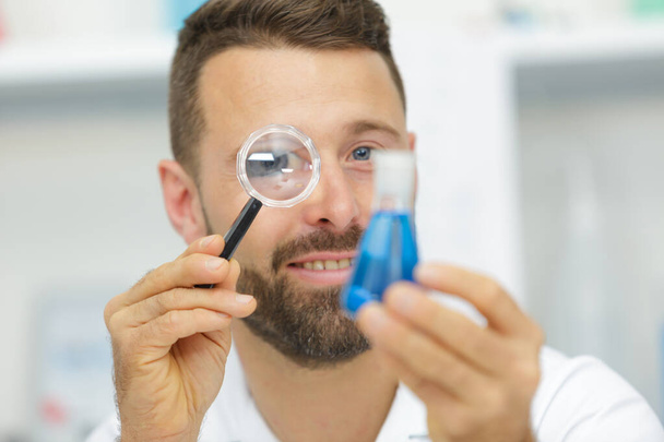happy man looking at mite through magnifier - Фото, зображення