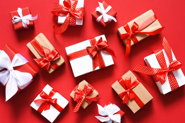 Boxes with ribbons on a red background.Present - Photo, image