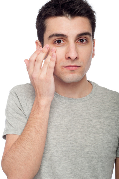Young man applying eye cream - Fotografie, Obrázek