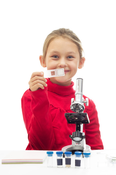 little girl holding a glass slide for the microscope - Фото, изображение