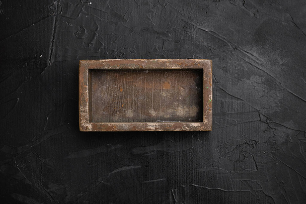 Rustic wooden box or container set with copy space for text or food, top view flat lay, on black dark stone table background - Valokuva, kuva