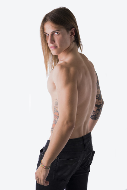 Long haired man with tattoos - Фото, зображення