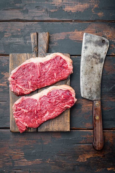 Veiny steak, marbled beef raw meat, on dark wooden background, top view - Фото, изображение