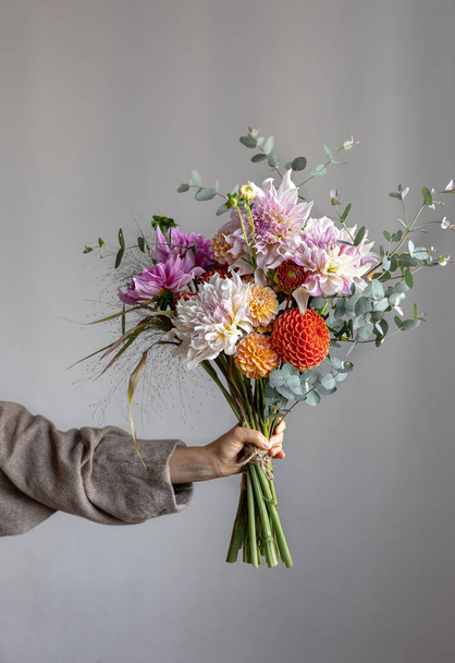A bouquet of beautiful chrysanthemums in a womans hand, copy space. - Foto, Bild