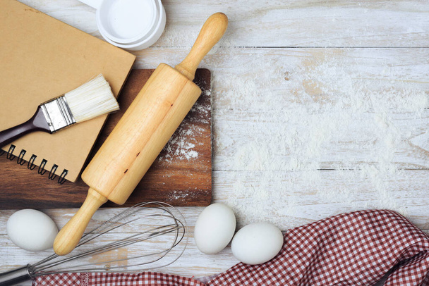 Homemade flour mixture, eggs, flour, milk, sugar on a wooden table, viewed from above. - Foto, Bild