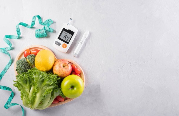 World diabetes day and healthcare concept. Diabetic measurement set, measure tape and healthy food eating nutrition in plate on stone background. - Photo, Image