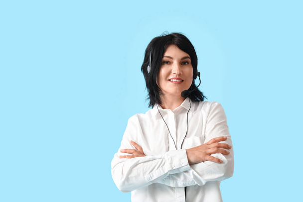 Reife Beraterin eines Call Centers im Headset auf blauem Hintergrund - Foto, Bild