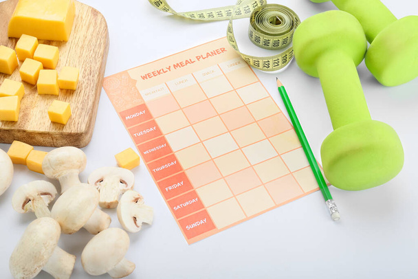 Meal plan with healthy products, measuring tape and dumbbells on white background - Photo, Image