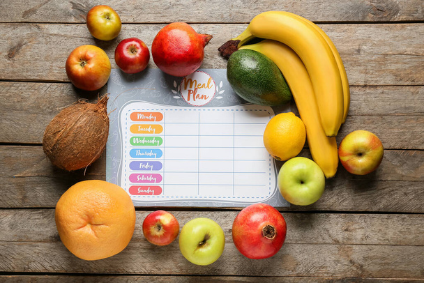 Fresh fruits and meal plan on wooden background - Photo, Image