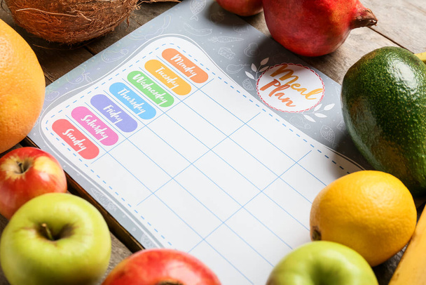 Fresh fruits with meal plan on table, closeup - Photo, Image