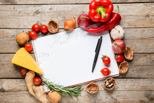 Healthy fresh products with meal plan on wooden background - Photo, Image